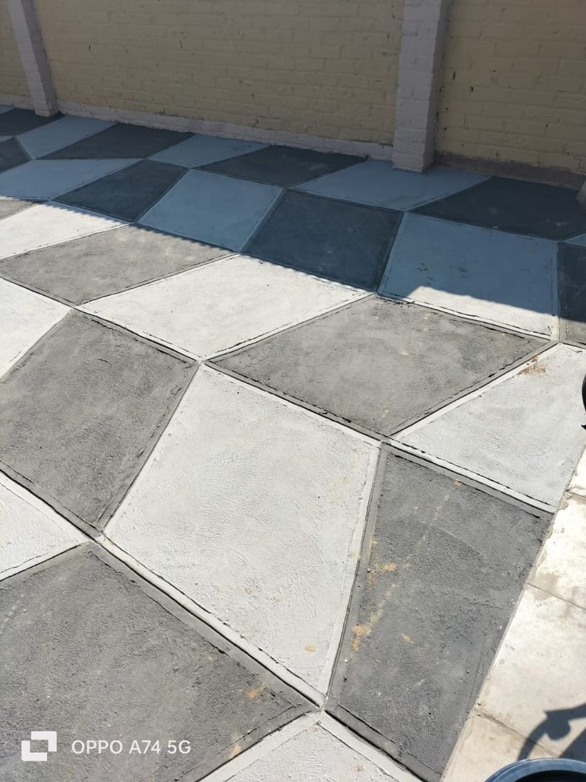 Elegant light grey and white large-format diamond scored concrete patio