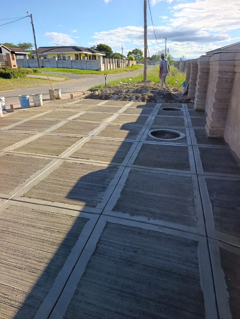 Grey scored concrete walkway with circular decorative insets