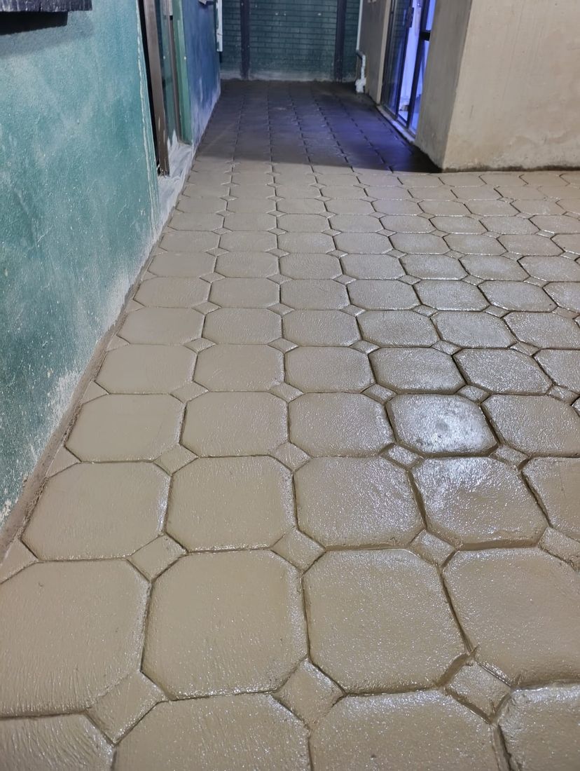 Hexagon tile pattern decorative concrete walkway leading to an entrance