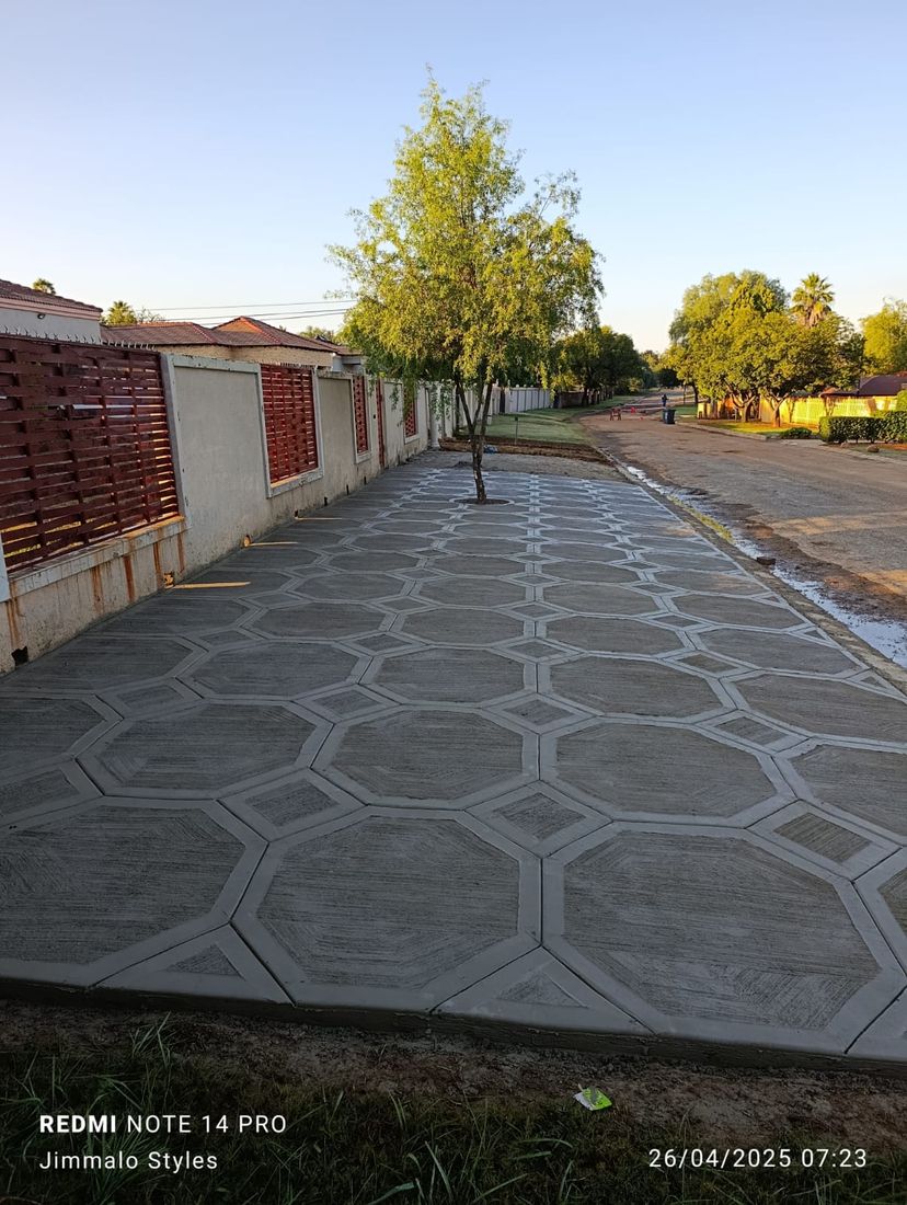 Grey octagon pattern decorative concrete driveway along a street