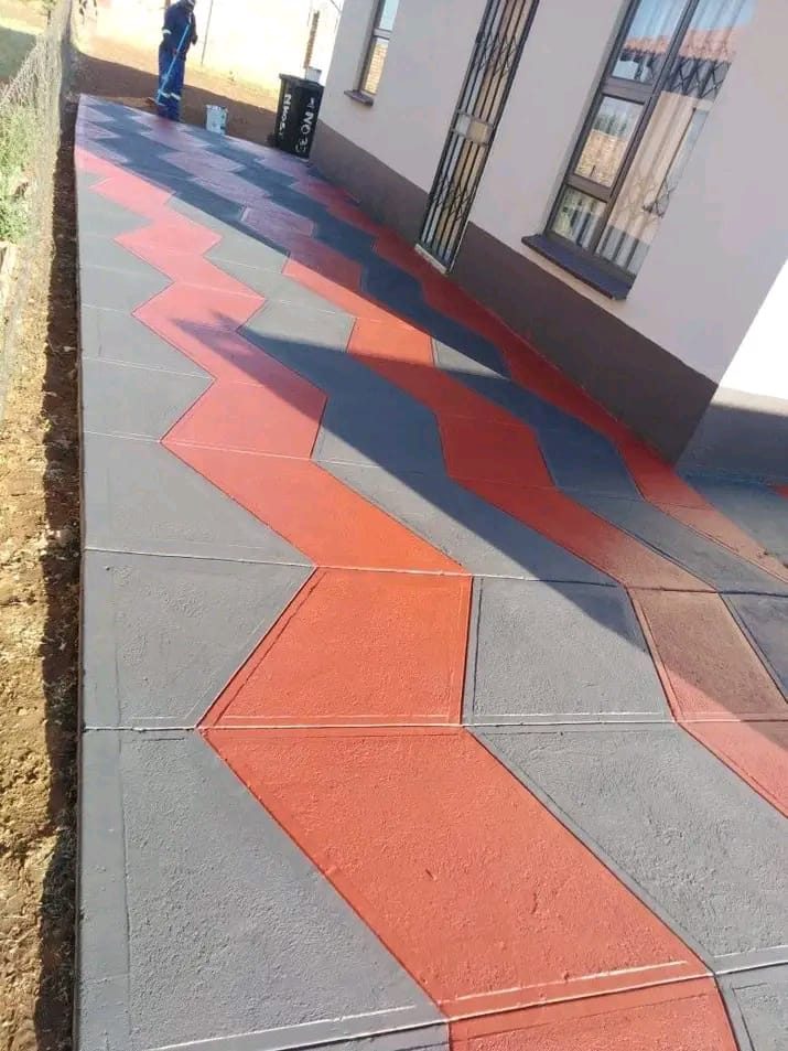 Jimmalo Styles Construction team member on a finished zigzag chevron pattern concrete walkway